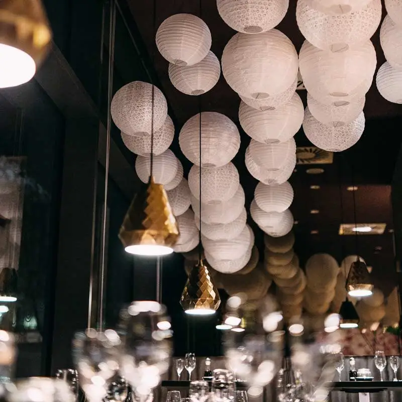 Paper lanterns and golden pendant lamps on the ceiling at Mikôto Stuttgart